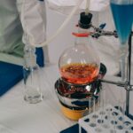 Laboratory equipment set up for chemical reactions with various colored liquids