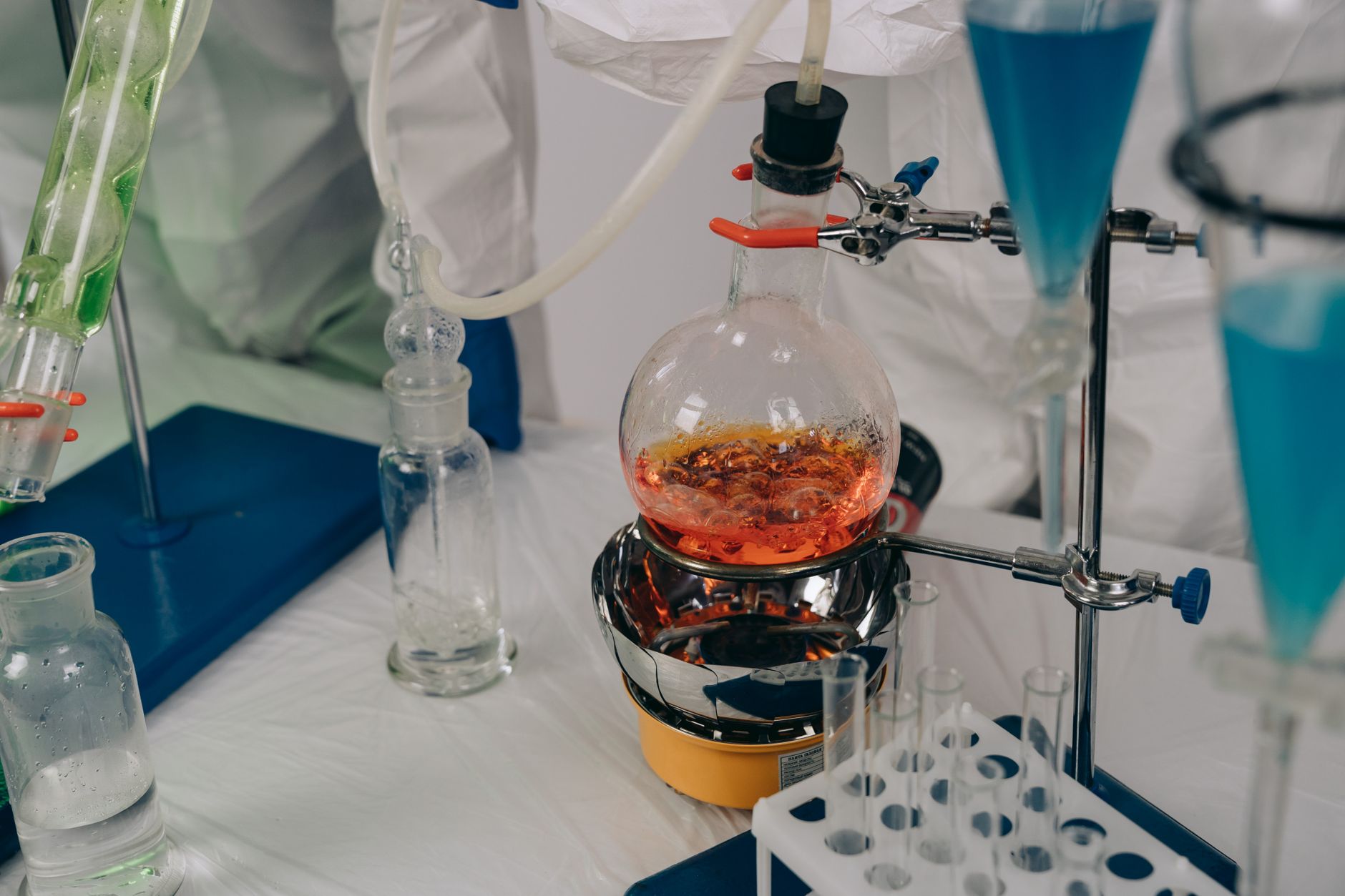 Laboratory equipment set up for chemical reactions with various colored liquids