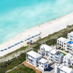 Aerial view of Alys Beach, showcasing beachfront properties and white sand along turquoise waters.