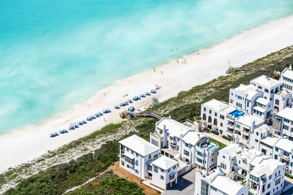 Aerial view of Alys Beach, showcasing beachfront properties and white sand along turquoise waters.
