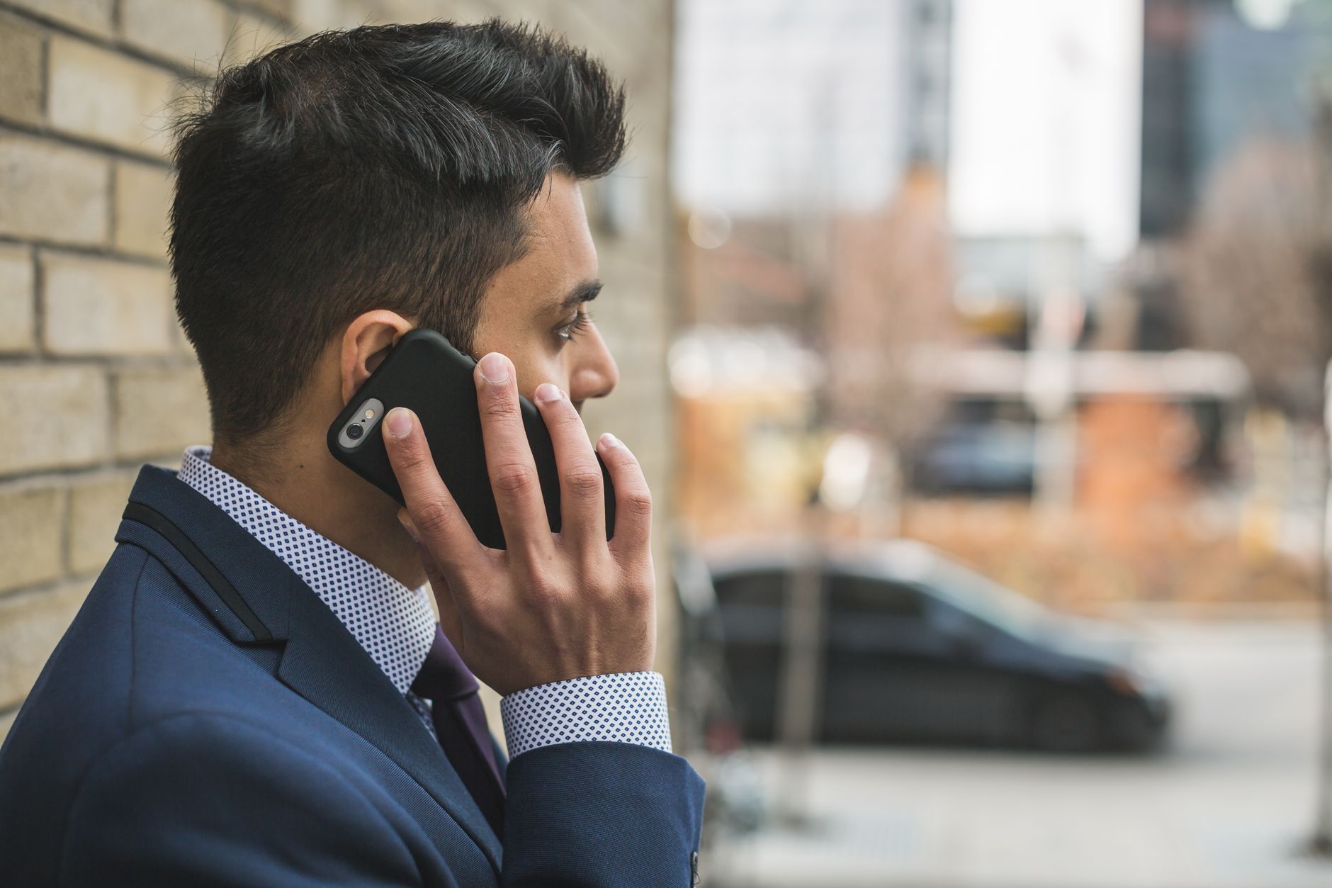 Professional man in suit making a phone call outside in city setting. — Balancing Personal Passions and Professional Excellen