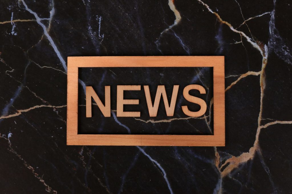 Wooden text of 'news' outlined on a dark, marbled surface, creating a striking contrast. — Bu1288: Your Ultimate Destination