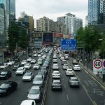 Heavy traffic on a busy Shanghai street lined with skyscrapers and billboards during the day. — Dr Zachary Solomon Philadelph