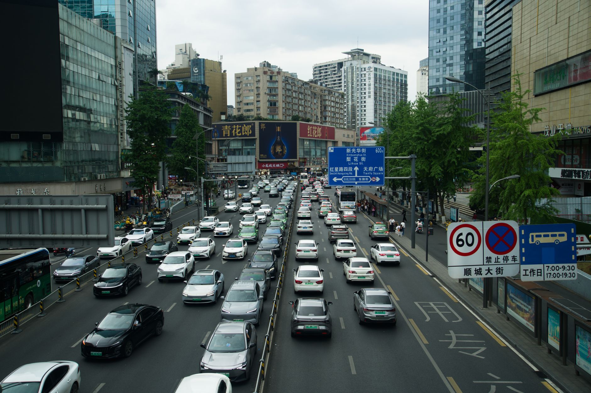 Heavy traffic on a busy Shanghai street lined with skyscrapers and billboards during the day. — Dr Zachary Solomon Philadelph