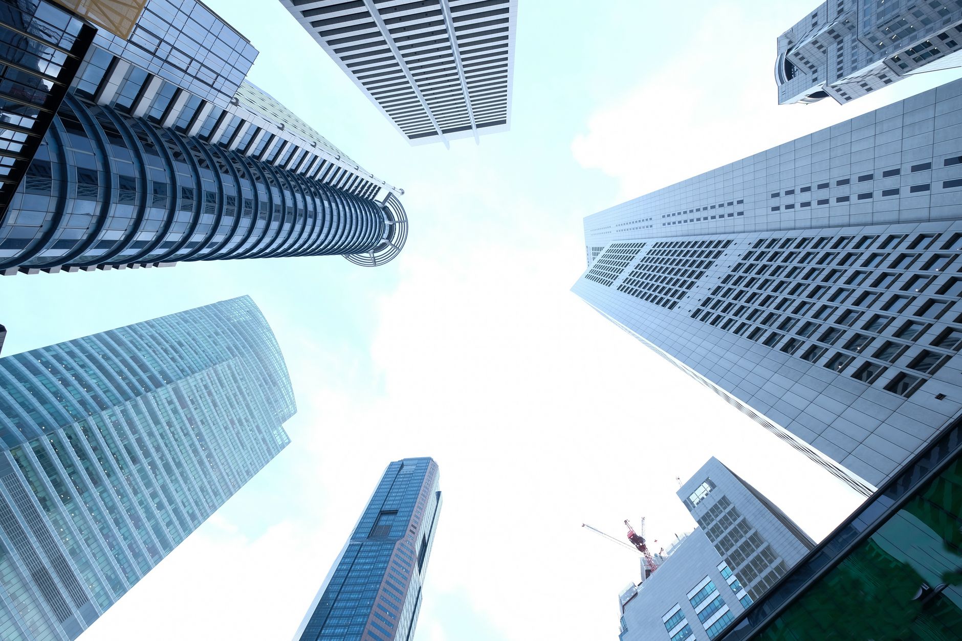 A striking upward view of various skyscrapers in an urban setting against a clear sky. — Eric Hollifield Atlanta 's Record-Se