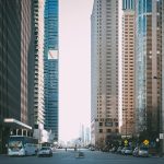 Vibrant city street scene with tall skyscrapers and city life full of cars and pedestrians. — From Tryouts to Triumph: Select