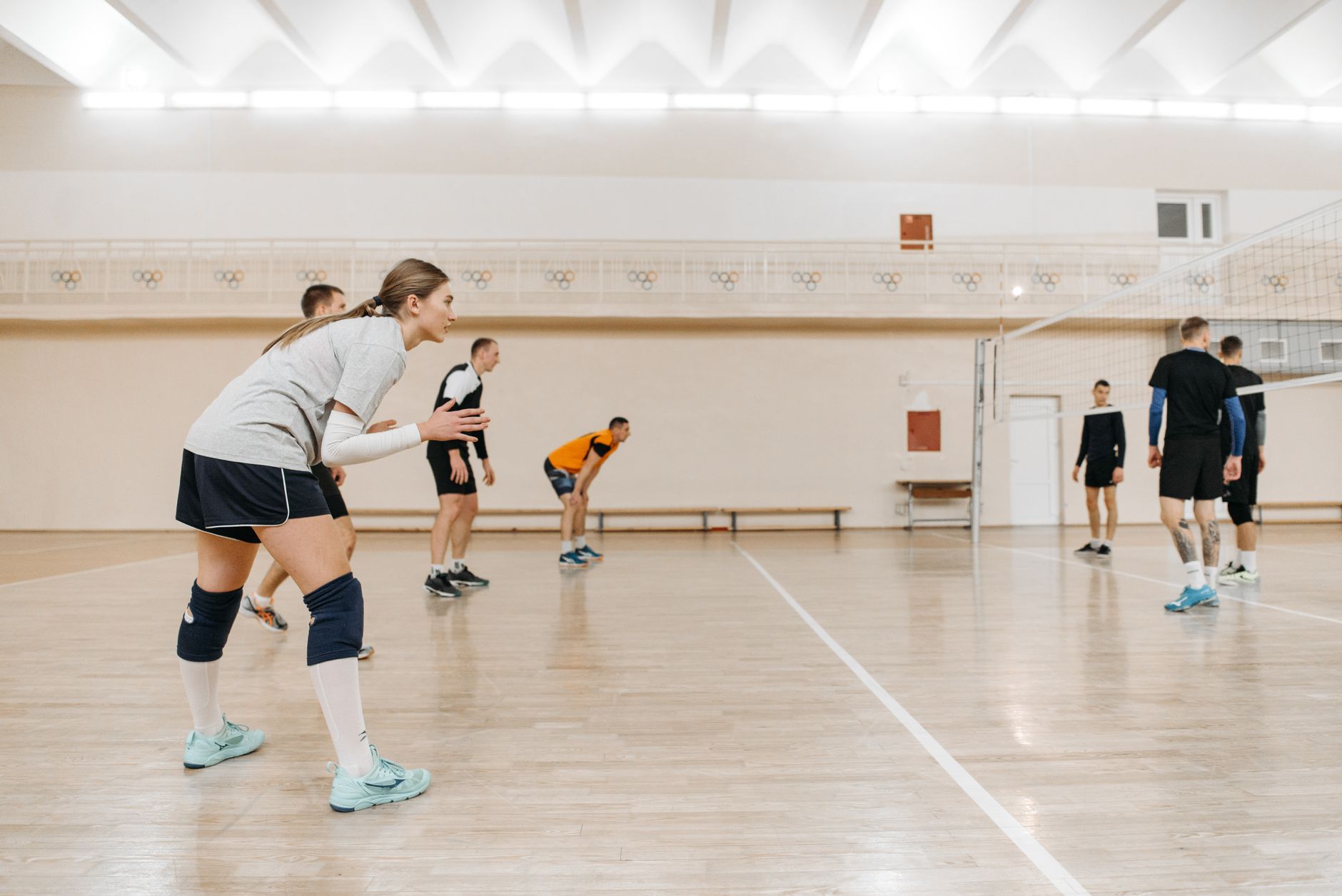 Athletes playing an intense volleyball match indoors, showcasing teamwork and sportsmanship. — La Grada Online: The Most Reli