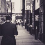 Man in a suit walking down a city street in a lonely, urban setting. — Martin Silver's Green Marketing Blueprint: Winning Cus