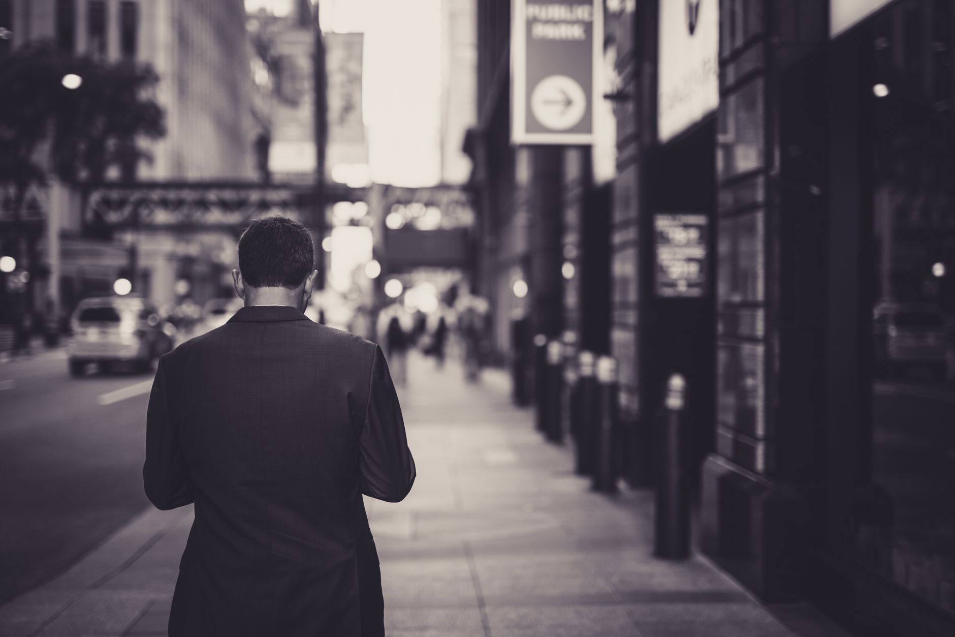 Man in a suit walking down a city street in a lonely, urban setting. — Martin Silver's Green Marketing Blueprint: Winning Cus