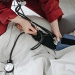 A medical professional checking a patient's blood pressure using a sphygmomanometer in a cozy setting. — Nangs: Fast and Effi