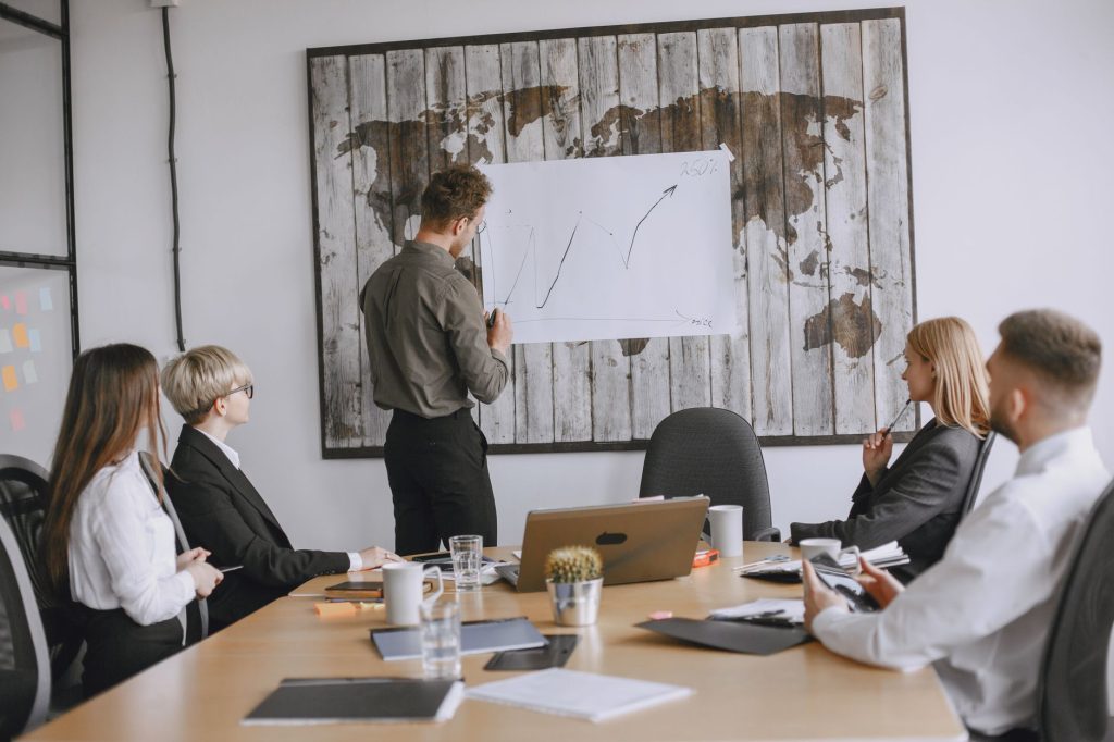 Group of business professionals discussing strategies with growth chart in conference room. — Panerai Replica Watches: Style