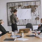 Group of business professionals discussing strategies with growth chart in conference room. — Panerai Replica Watches: Style