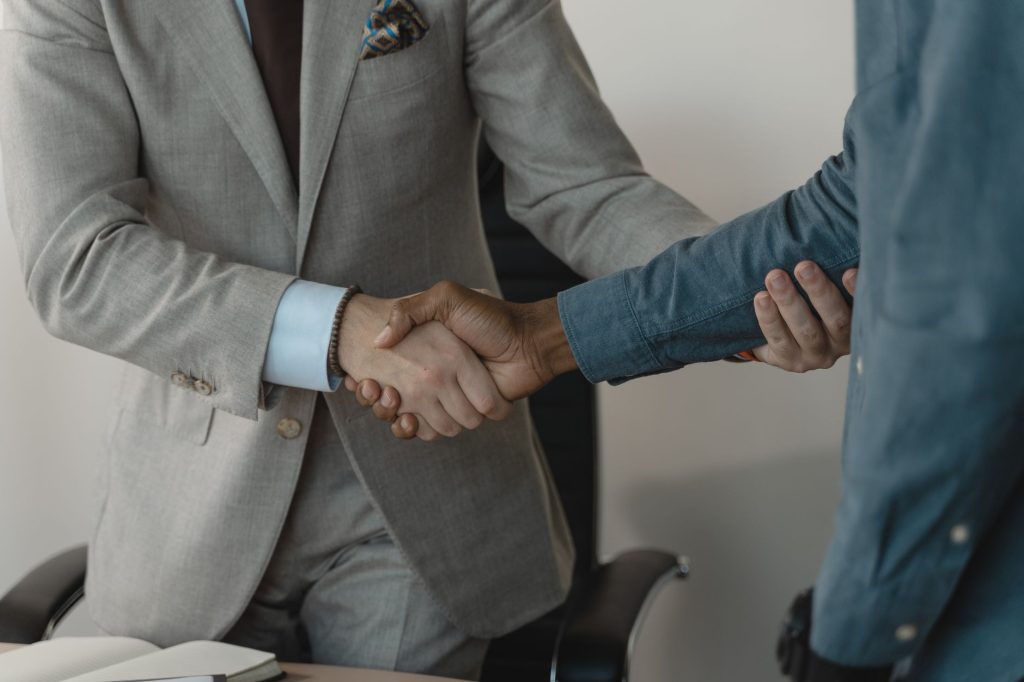 Image of a professional handshake between two businessmen in an office setting. — Stay Updated with Working Links for Active