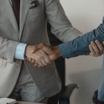 Image of a professional handshake between two businessmen in an office setting. — Stay Updated with Working Links for Active