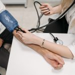 A doctor measures a patient's blood pressure with a sphygmomanometer during a consultation. — The Surgical Expertise and Exec