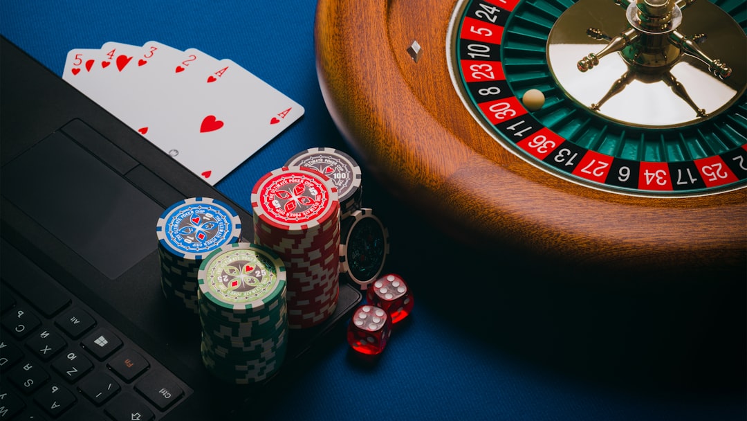 A close-up of poker chips, playing cards, and a roulette wheel on a blue background.